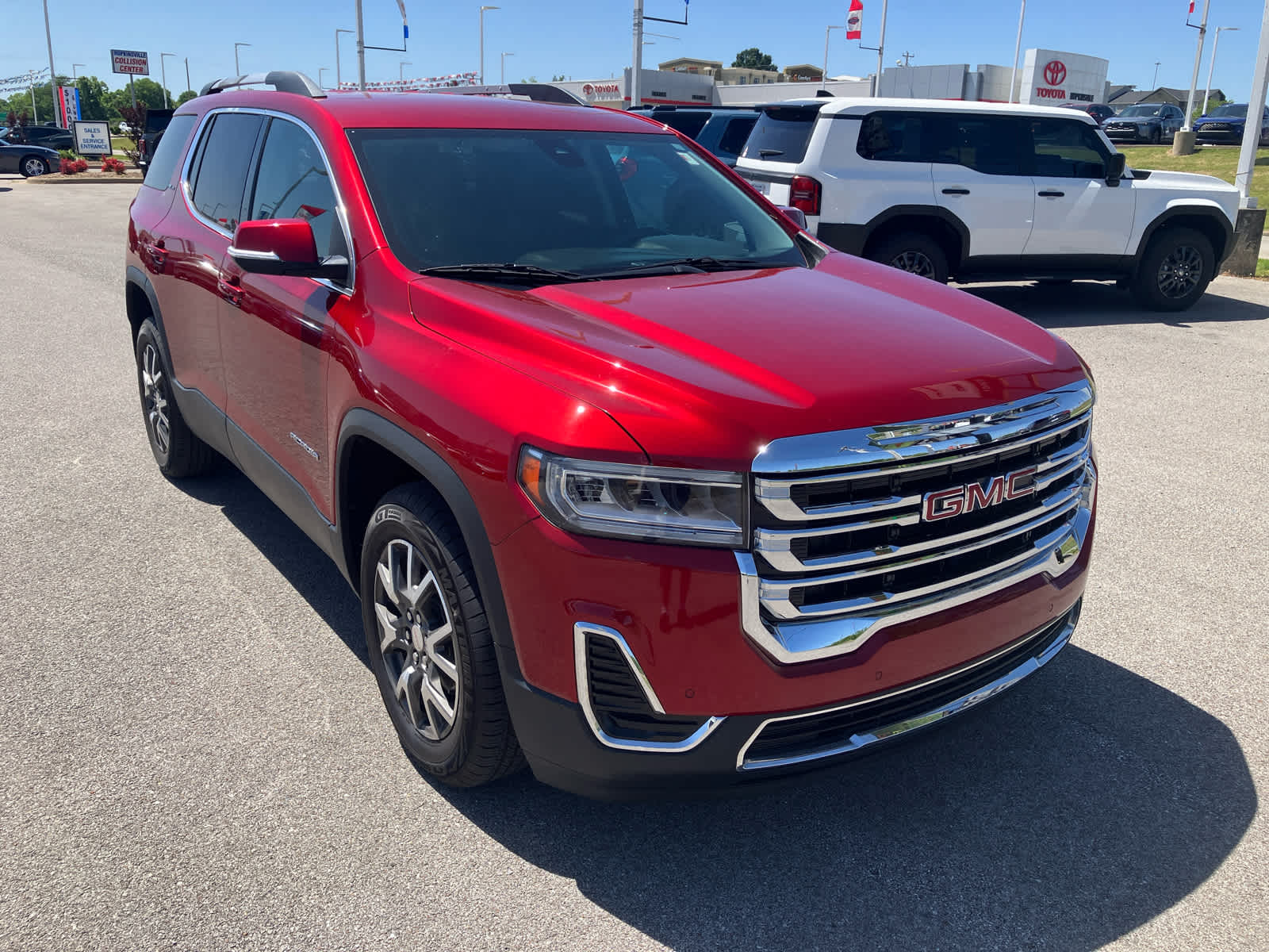 2021 GMC Acadia SLE in Cayenne Red Tintcoat — front three-quarter view
