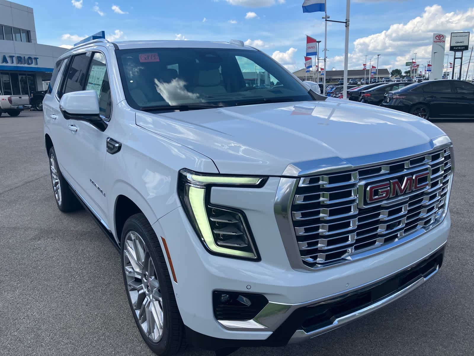 2026 GMC Yukon Denali in Glacier White Tricoat — front three-quarter view